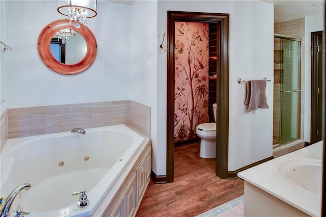 full bathroom with separate shower and tub, vanity, a notable chandelier, and toilet