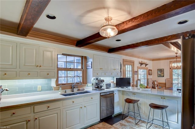 kitchen featuring tasteful backsplash, kitchen peninsula, dishwasher, and sink