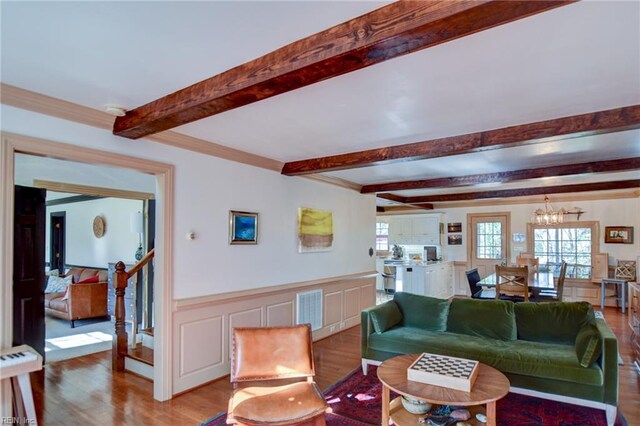 living room featuring light wood-type flooring and an inviting chandelier