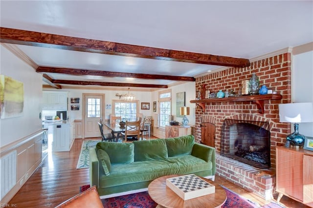 living room featuring hardwood / wood-style floors, a fireplace, and beamed ceiling