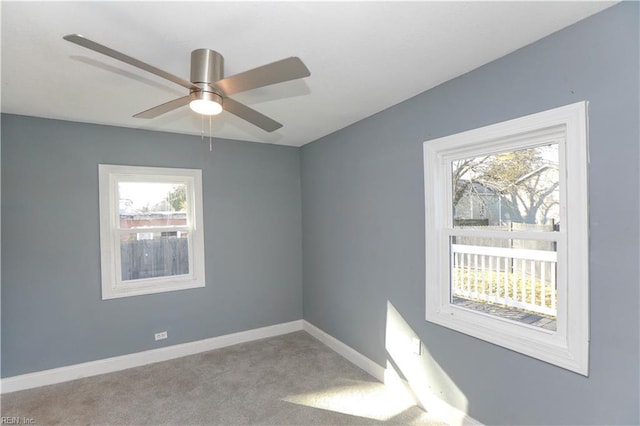 spare room featuring light carpet and ceiling fan