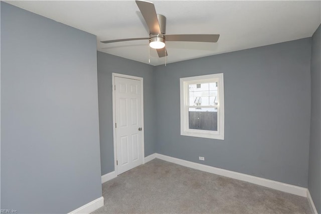 unfurnished room featuring ceiling fan and light colored carpet