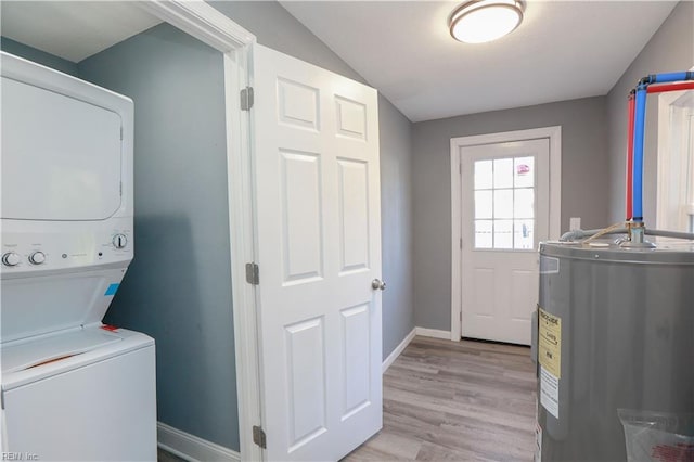 washroom featuring stacked washer / dryer, water heater, and light wood-type flooring