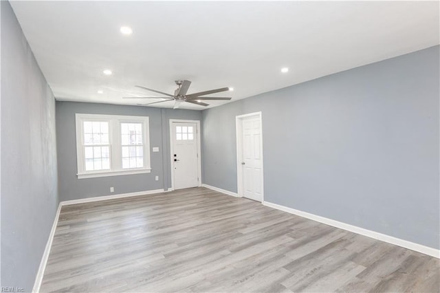 spare room with light hardwood / wood-style flooring and ceiling fan