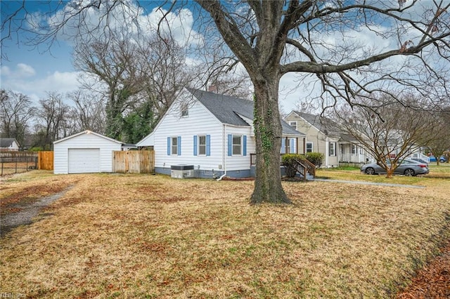 exterior space with cooling unit, a garage, an outdoor structure, and a front yard