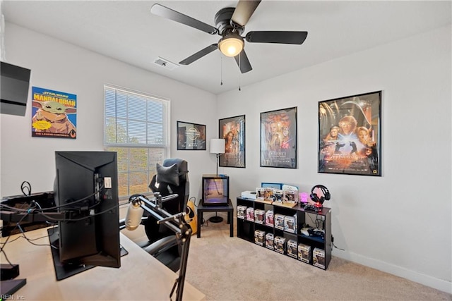 office space featuring ceiling fan and light colored carpet