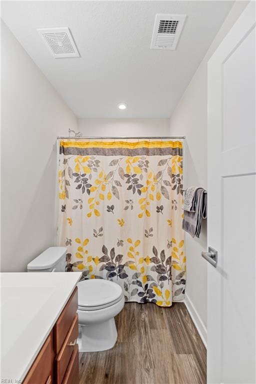 bathroom featuring hardwood / wood-style flooring, vanity, toilet, and a shower with shower curtain