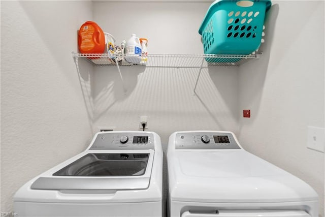 clothes washing area featuring separate washer and dryer