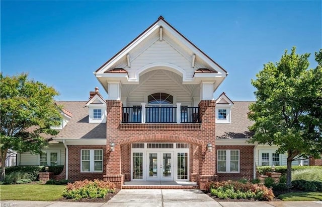 view of front of house featuring french doors and a balcony