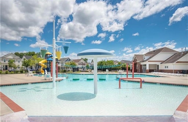 view of swimming pool featuring a patio and a water slide