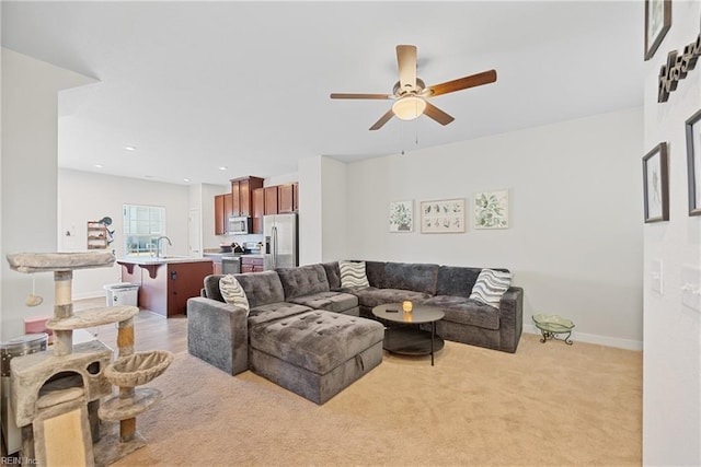 living room with ceiling fan and light colored carpet