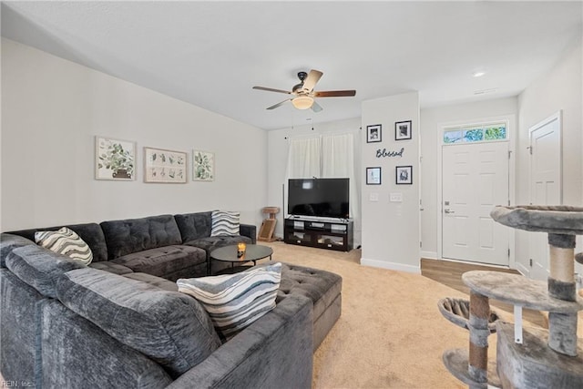 living room featuring ceiling fan and light colored carpet