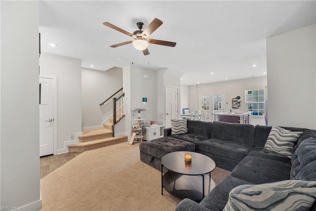 living room featuring ceiling fan and light hardwood / wood-style flooring