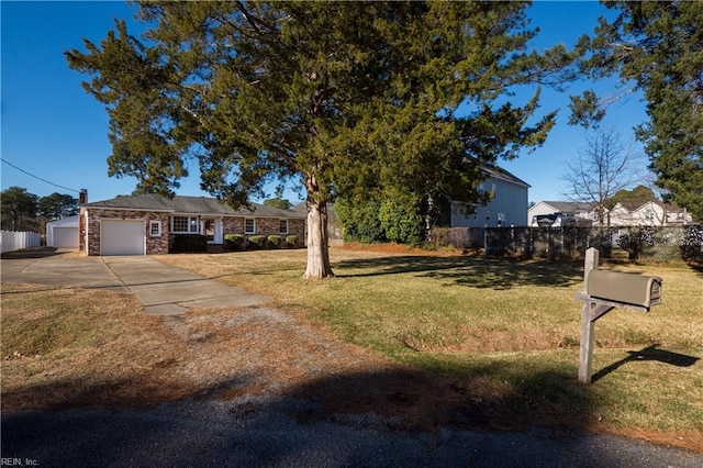 view of front of property with a garage and a front lawn