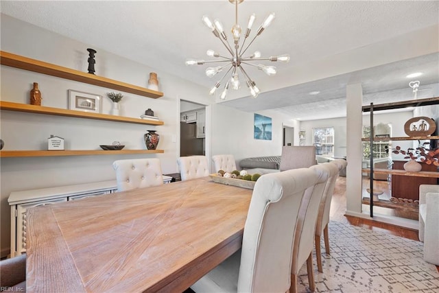 dining space featuring light hardwood / wood-style flooring and a chandelier