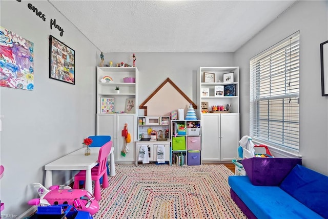 rec room with a textured ceiling