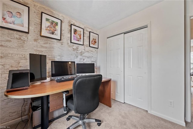 carpeted office with a textured ceiling