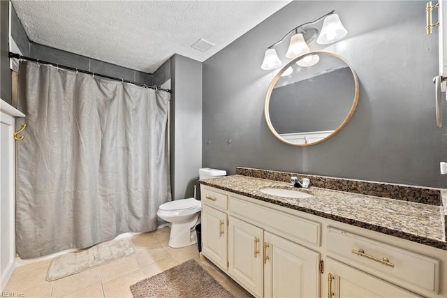 bathroom featuring tile patterned floors, vanity, toilet, and a textured ceiling