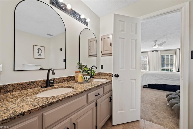 bathroom featuring a textured ceiling, vanity, tile patterned floors, and ceiling fan