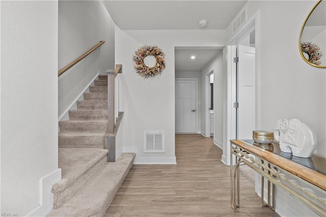 foyer entrance with light hardwood / wood-style flooring