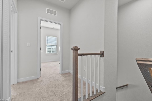 hallway with light colored carpet