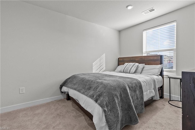 bedroom with light colored carpet