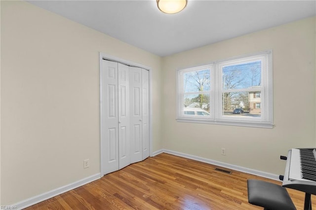 unfurnished bedroom with light hardwood / wood-style floors and a closet