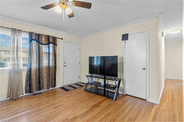 living room featuring ceiling fan, light hardwood / wood-style floors, and ornamental molding