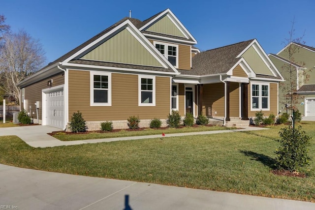 craftsman house with a front yard and a garage