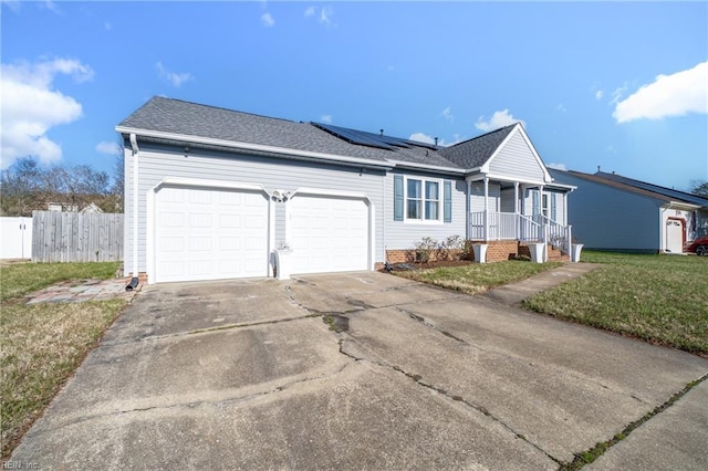 view of front of house with solar panels, a garage, and a front lawn