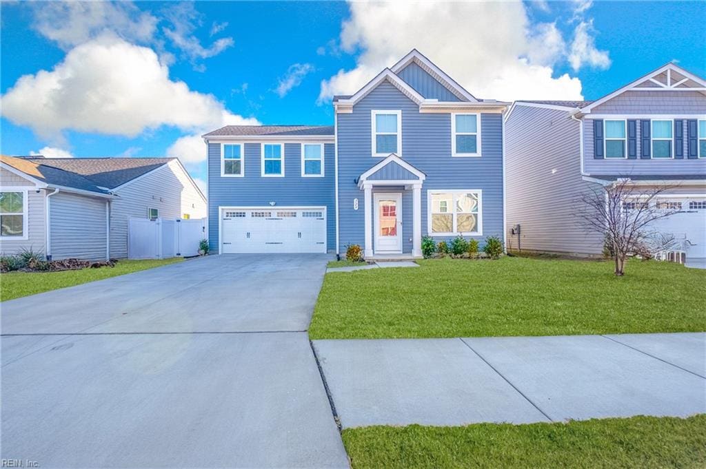 view of front of house with a front yard and a garage