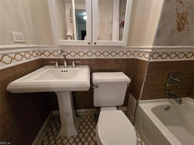 bathroom with  shower combination, toilet, and tile walls