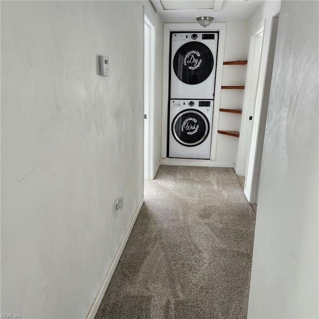 hall with carpet flooring and stacked washing maching and dryer