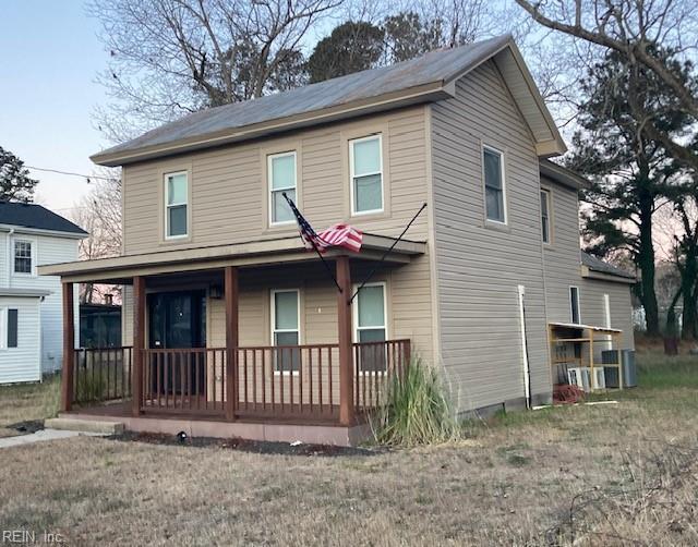 view of front of property with covered porch and a front yard