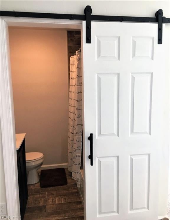 full bathroom featuring toilet, vanity, shower / bath combination with curtain, and hardwood / wood-style flooring