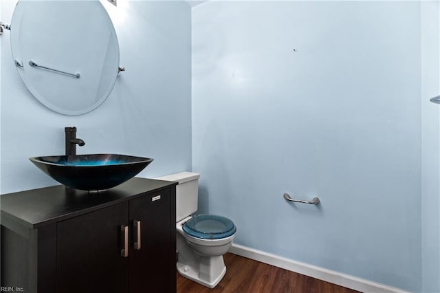 bathroom featuring hardwood / wood-style flooring, vanity, and toilet