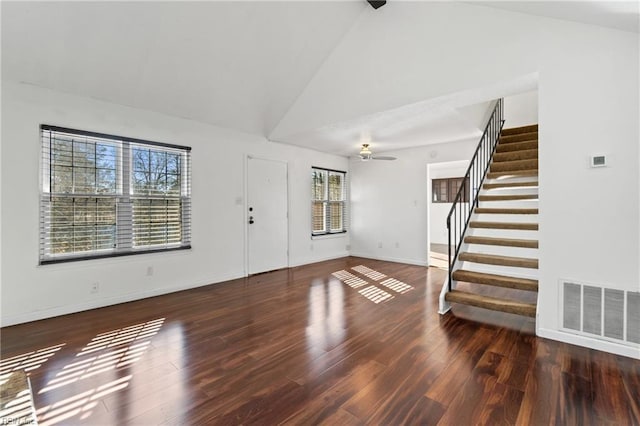 foyer with ceiling fan, dark wood-type flooring, and high vaulted ceiling