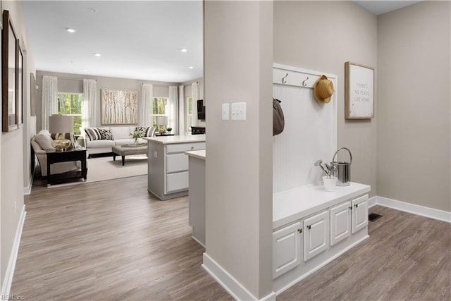 corridor with light hardwood / wood-style floors