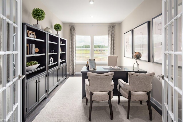 home office featuring french doors and hardwood / wood-style flooring