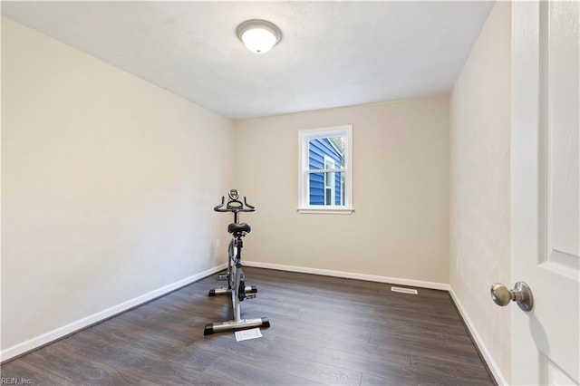 exercise room with dark hardwood / wood-style flooring