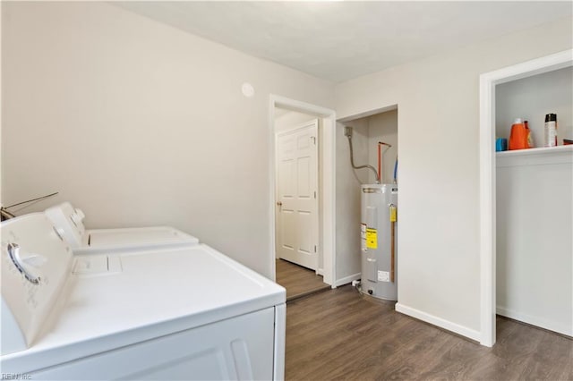 washroom with separate washer and dryer, water heater, and dark hardwood / wood-style flooring