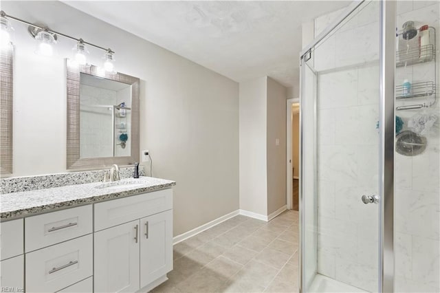 bathroom featuring tile patterned floors, vanity, and walk in shower