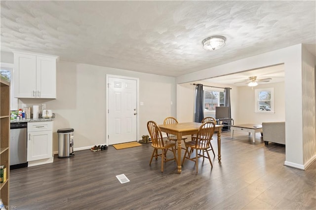 dining area with a textured ceiling, dark hardwood / wood-style flooring, and ceiling fan