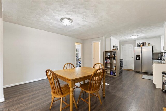 dining room featuring dark hardwood / wood-style floors and a textured ceiling