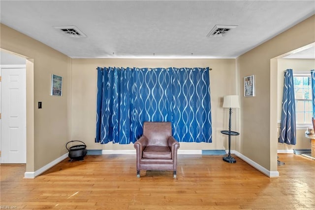 sitting room with wood-type flooring