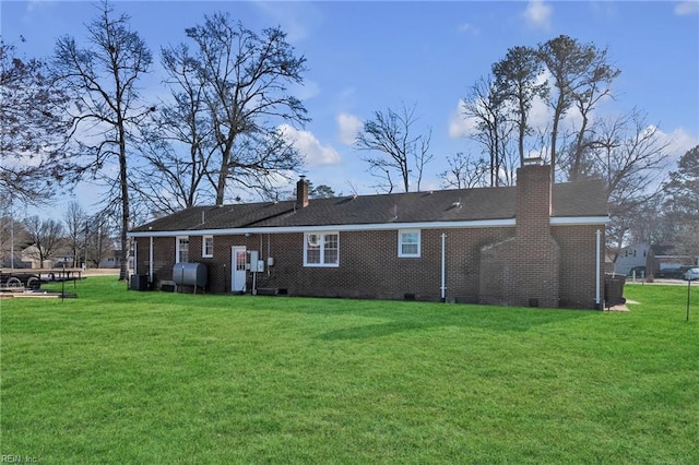 rear view of property with a yard