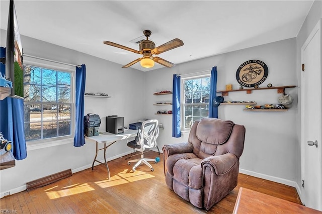 office space with light hardwood / wood-style floors and ceiling fan