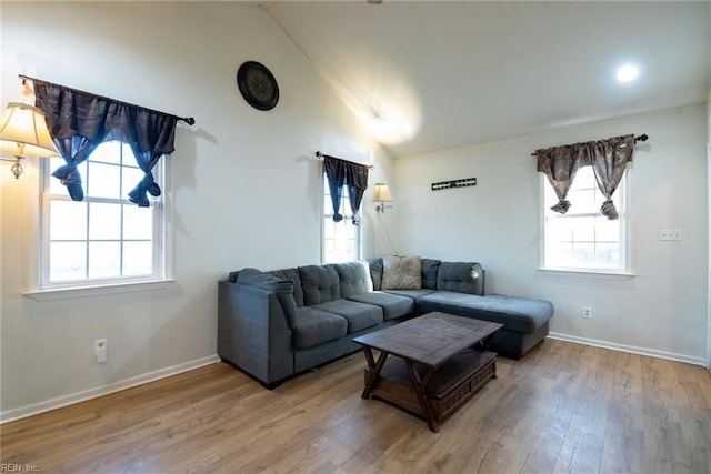 living room featuring hardwood / wood-style floors and vaulted ceiling