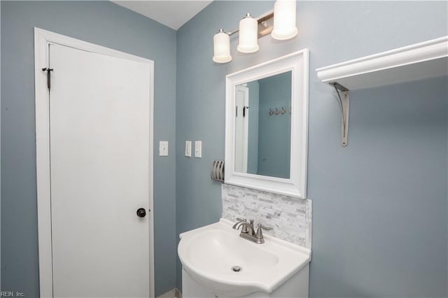 bathroom featuring decorative backsplash and sink