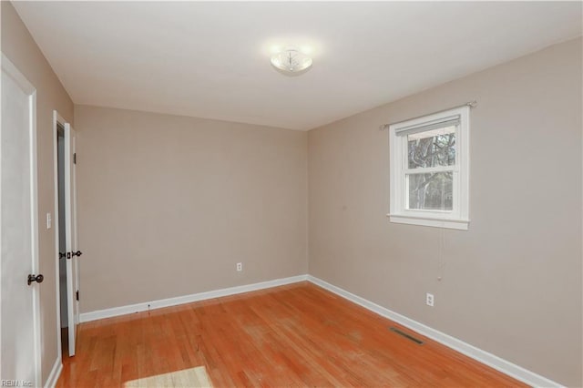 unfurnished room with hardwood / wood-style floors